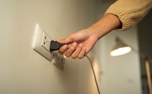 woman holding a plug